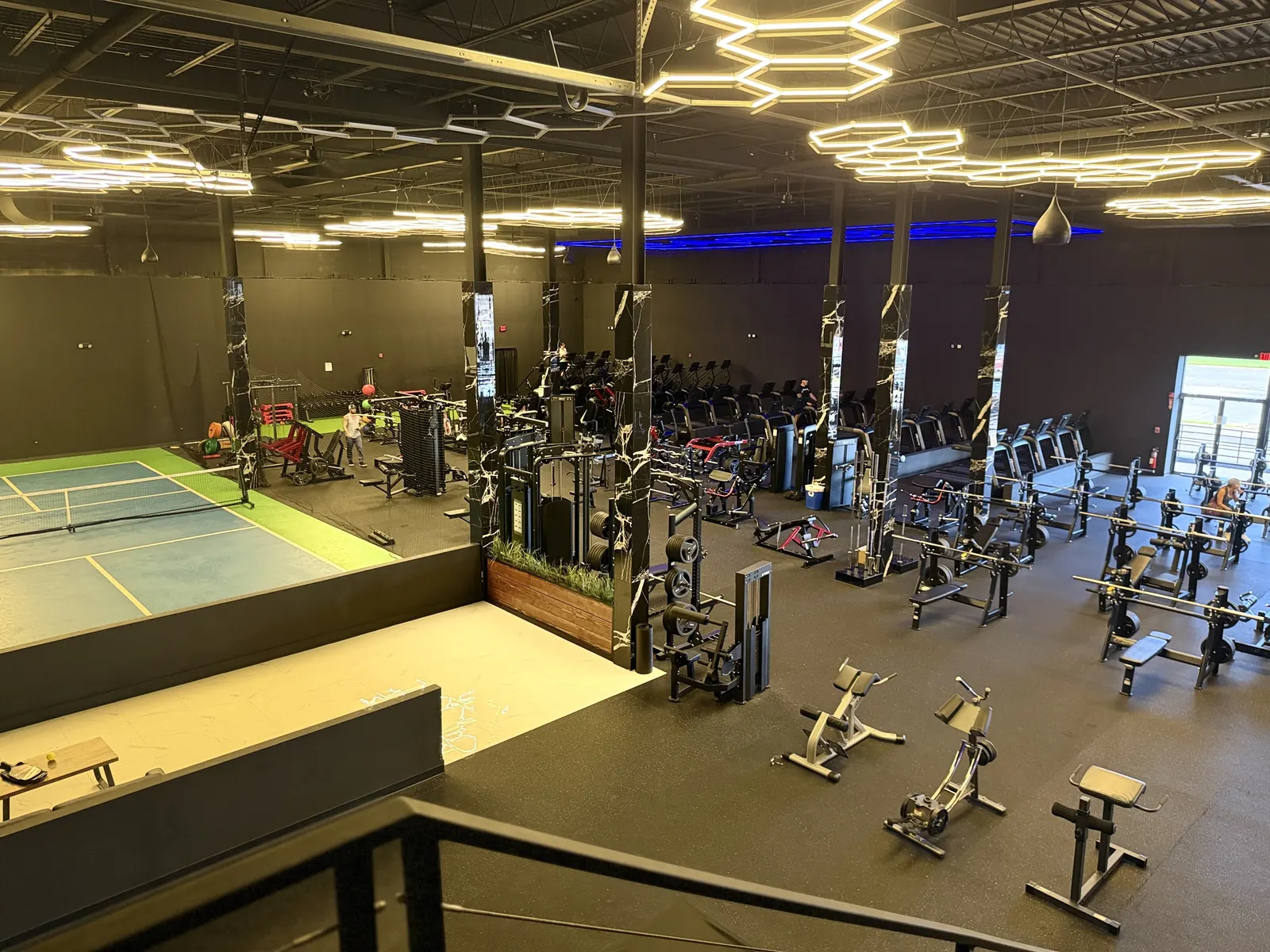 View from the mezzanine over the cardio and weight floor and the pickleball court