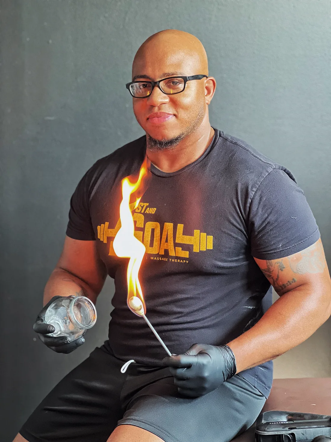 Tysef Meacham, founder of 1st & Goal Athletics, performing fire-cupping bodywork